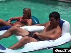 Girl gives blowjob in pool while other are around